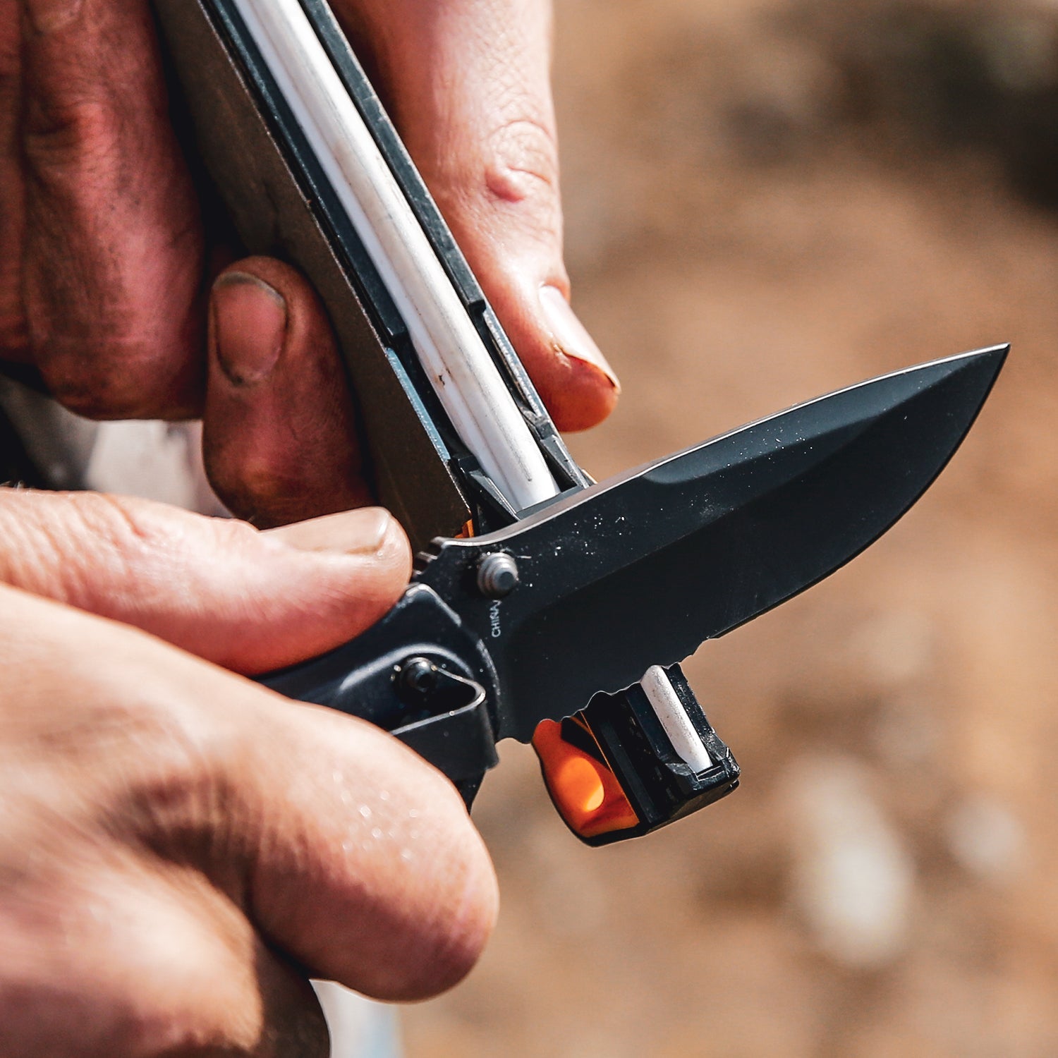 Worksharp Guided Field Sharpener sharpening a serrated knife blade